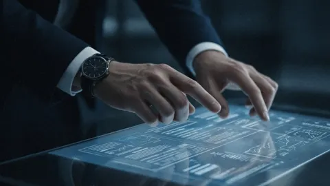 Still from Magnificent Remains: hands on a glowing glass display