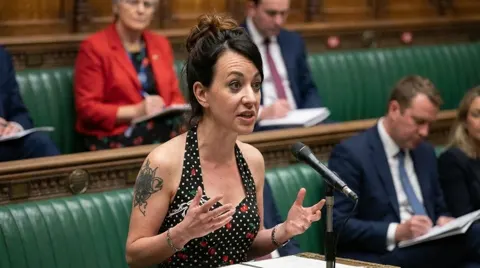 Still from The Sea Candle: Diddy Wheldon speaking in the House of Commons