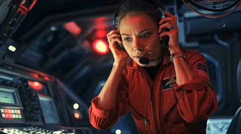 Still from Untethered: the astronaut in a headset calling for help